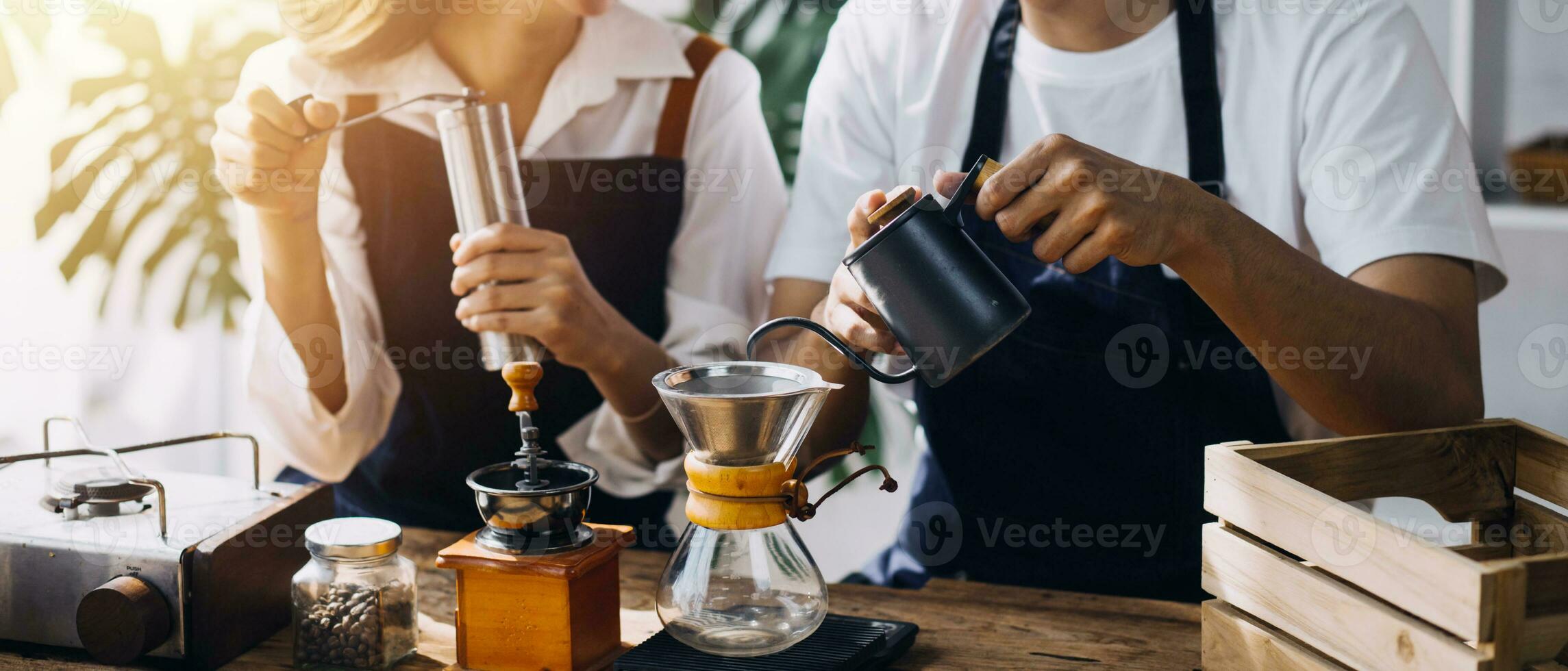 Happy young adult couple making breakfast and drinking coffee together in cozy home kitchen in morning at home. Preparing meal and smiling. Lifestyle, leisure and Love concept. photo