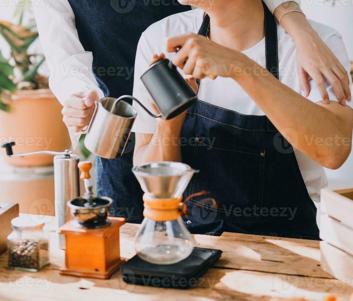 Happy young adult couple making breakfast and drinking coffee together in cozy home kitchen in morning at home. Preparing meal and smiling. Lifestyle, leisure and Love concept. photo
