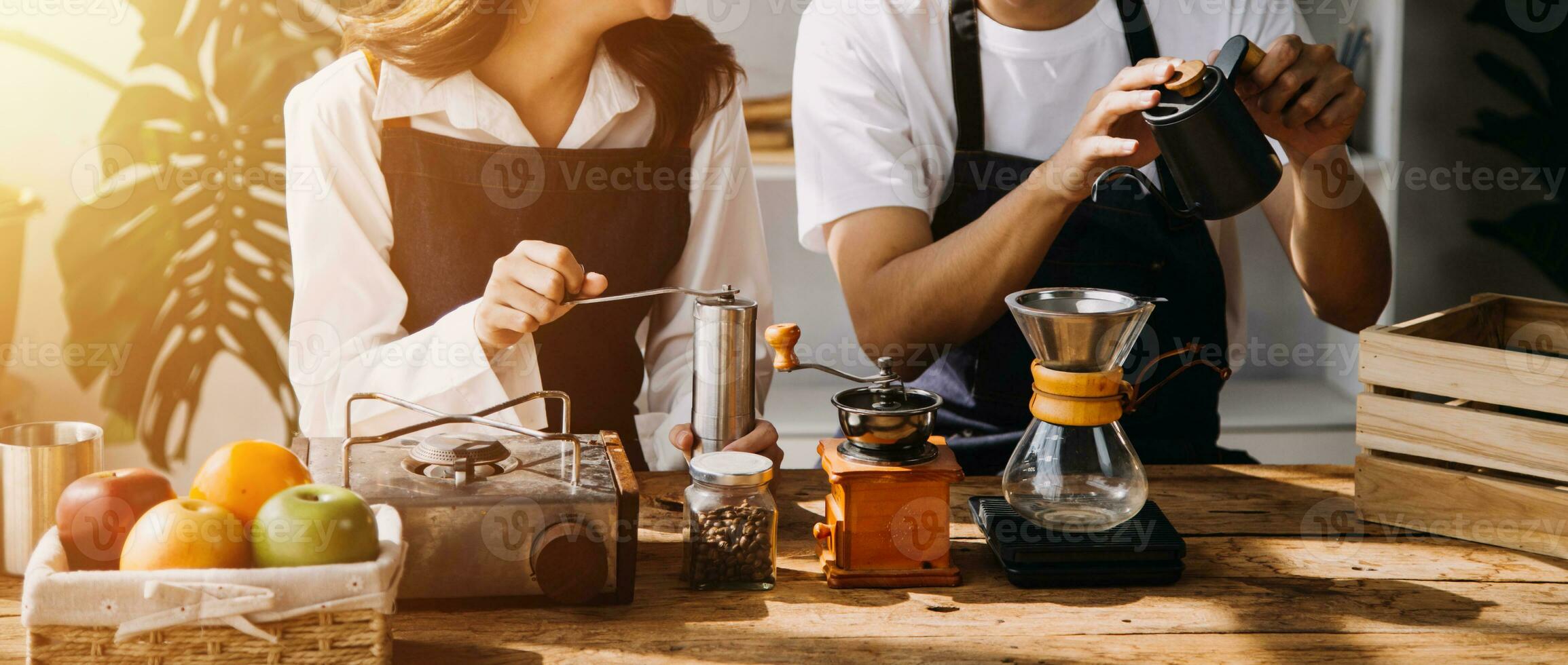 Happy young adult couple making breakfast and drinking coffee together in cozy home kitchen in morning at home. Preparing meal and smiling. Lifestyle, leisure and Love concept. photo