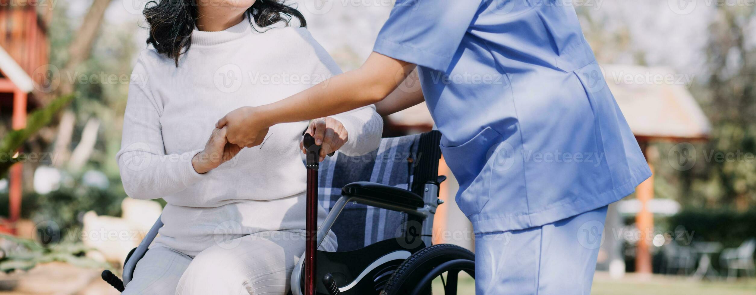 Asian young woman nurse at nursing home take care disabled senior man. Caregiver doctor serve physical therapy for older elderly patient to exercise and practice walking on walker or cane at backyard. photo