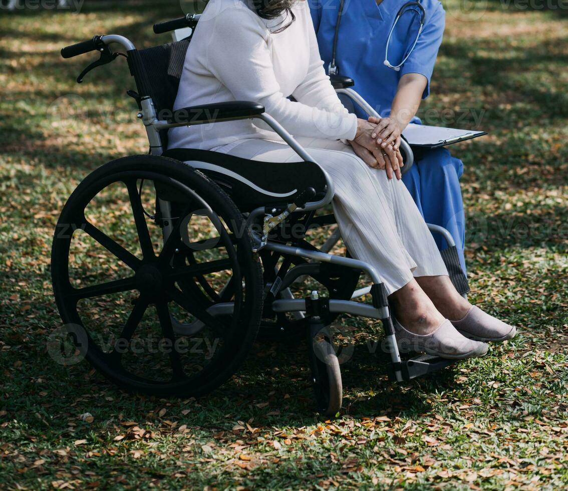 Asian young woman nurse at nursing home take care disabled senior man. Caregiver doctor serve physical therapy for older elderly patient to exercise and practice walking on walker or cane at backyard. photo