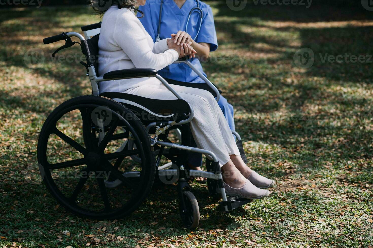 Asian young woman nurse at nursing home take care disabled senior man. Caregiver doctor serve physical therapy for older elderly patient to exercise and practice walking on walker or cane at backyard. photo