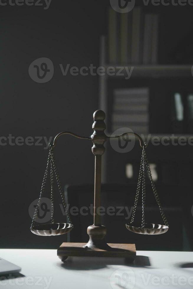 Business and lawyers discussing contract papers with brass scale on desk in office. Law, legal services, advice, justice and law concept picture with film grain effect photo