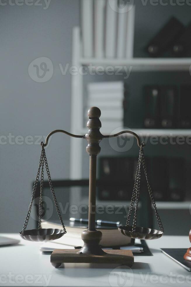 Business and lawyers discussing contract papers with brass scale on desk in office. Law, legal services, advice, justice and law concept picture with film grain effect photo