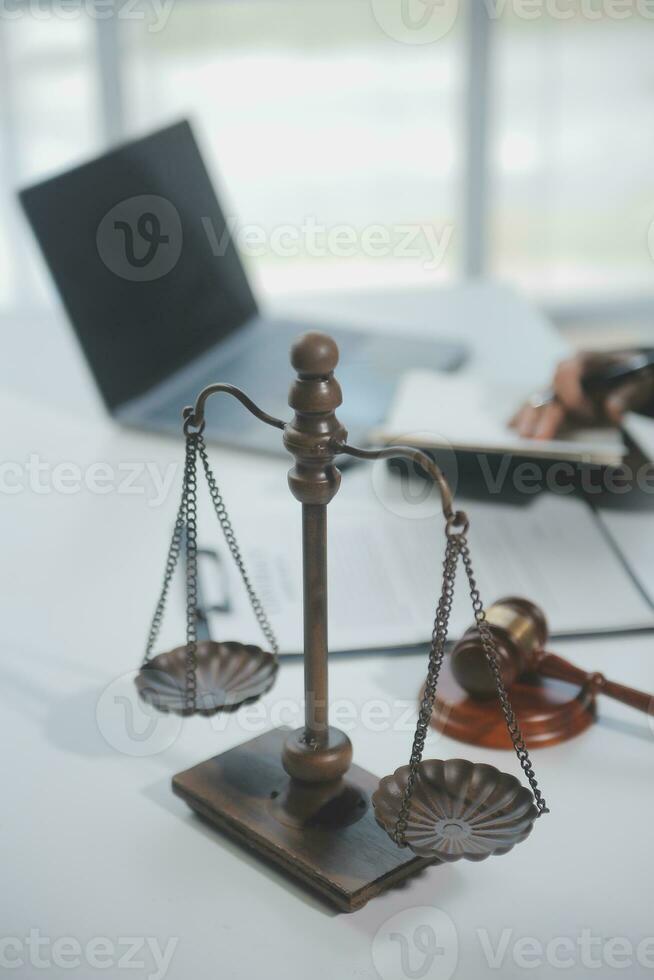 Business and lawyers discussing contract papers with brass scale on desk in office. Law, legal services, advice, justice and law concept picture with film grain effect photo