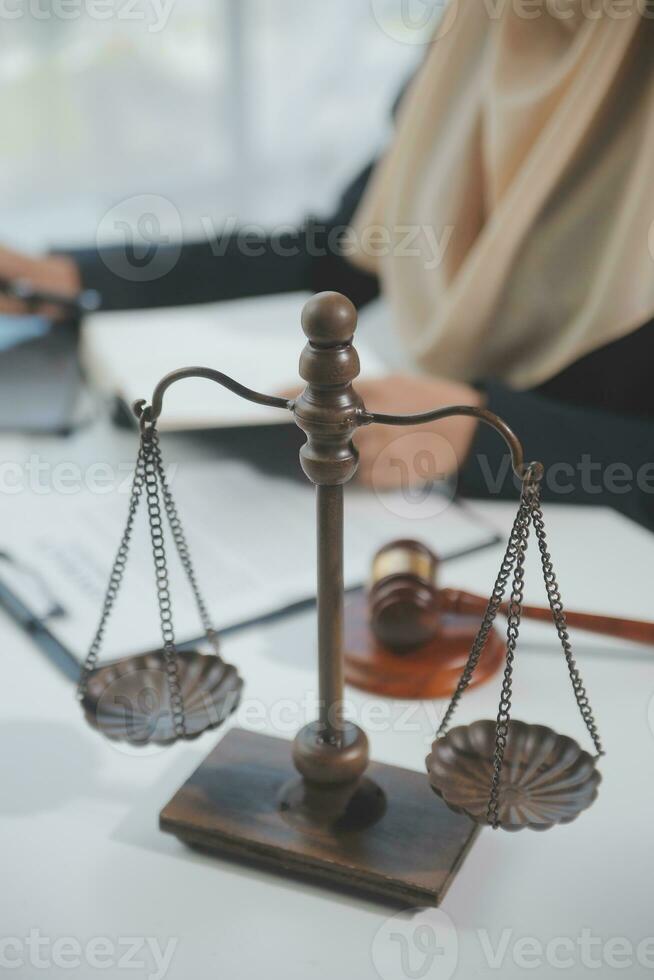 Business and lawyers discussing contract papers with brass scale on desk in office. Law, legal services, advice, justice and law concept picture with film grain effect photo