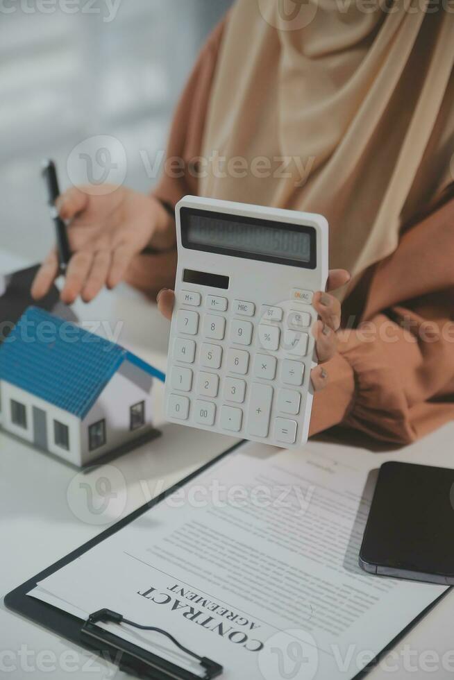 Real estate agent and customer signing contract to buy house, insurance or loan real estate.rent a house,get insurance or loan real estate or property. photo