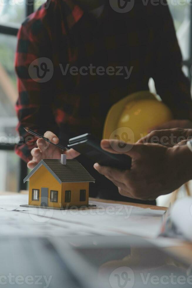 Engineer Teamwork Meeting, Drawing working on blueprint meeting for project working with partner on model building and engineering tools in working site, Construction and structure concept. photo