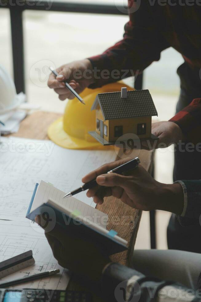 Engineer Teamwork Meeting, Drawing working on blueprint meeting for project working with partner on model building and engineering tools in working site, Construction and structure concept. photo