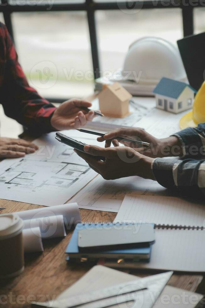 Engineer Teamwork Meeting, Drawing working on blueprint meeting for project working with partner on model building and engineering tools in working site, Construction and structure concept. photo