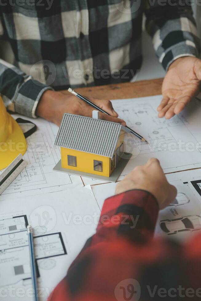 Engineer Teamwork Meeting, Drawing working on blueprint meeting for project working with partner on model building and engineering tools in working site, Construction and structure concept. photo