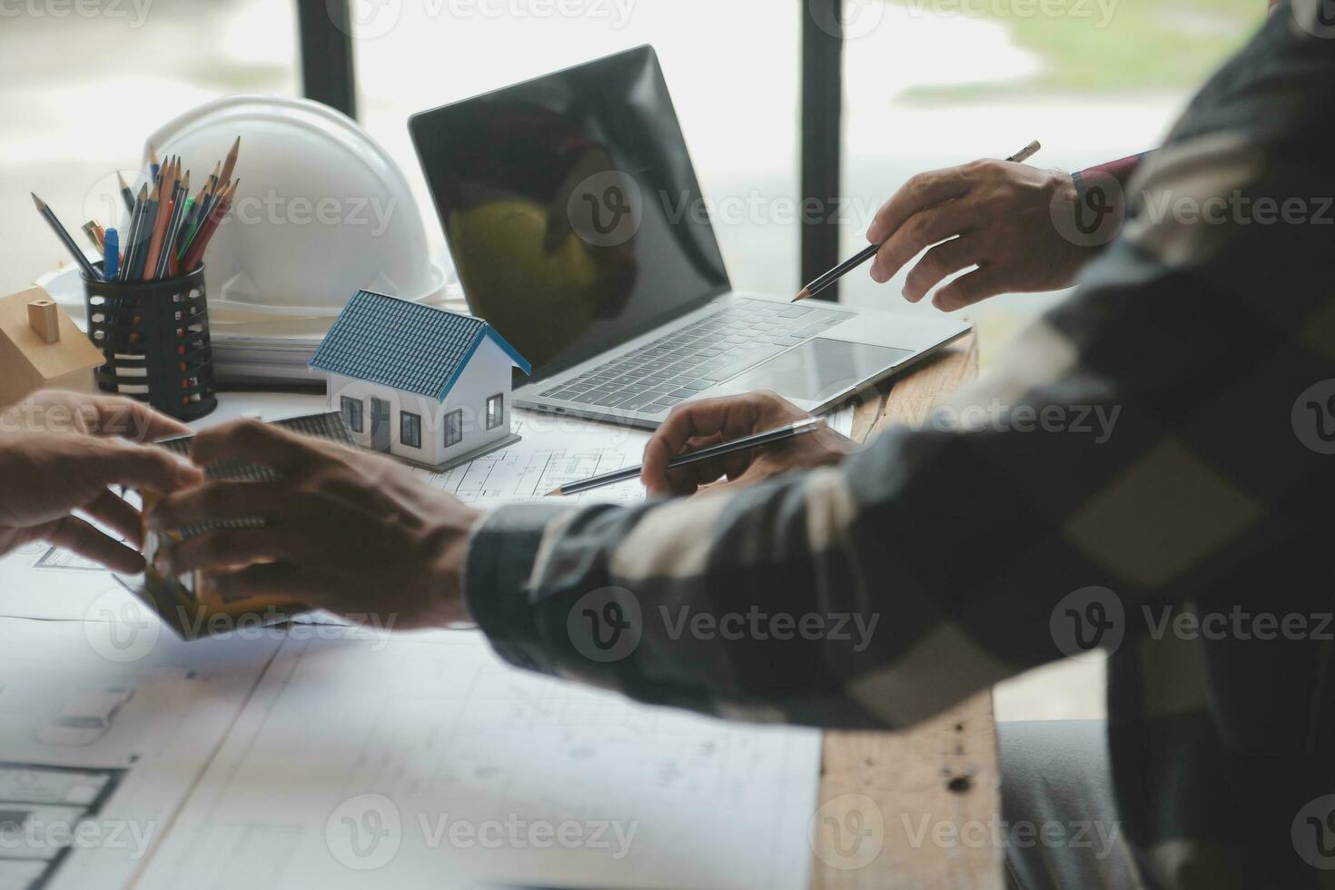 Engineer Teamwork Meeting, Drawing working on blueprint meeting for project working with partner on model building and engineering tools in working site, Construction and structure concept. photo