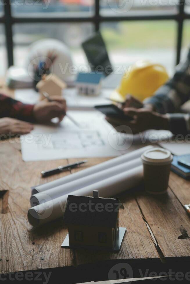 Engineer Teamwork Meeting, Drawing working on blueprint meeting for project working with partner on model building and engineering tools in working site, Construction and structure concept. photo