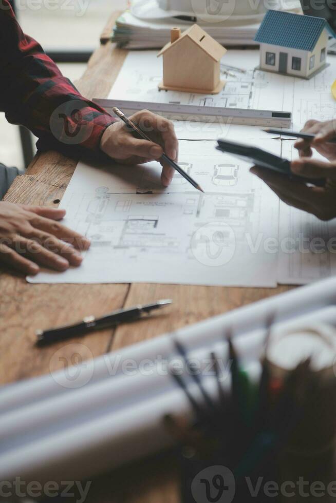 Engineer Teamwork Meeting, Drawing working on blueprint meeting for project working with partner on model building and engineering tools in working site, Construction and structure concept. photo