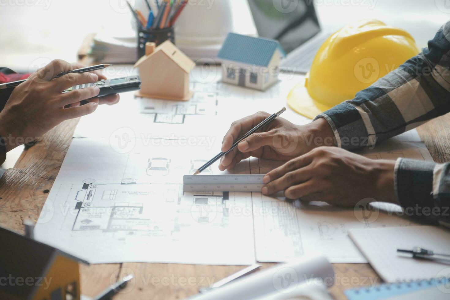 Engineer Teamwork Meeting, Drawing working on blueprint meeting for project working with partner on model building and engineering tools in working site, Construction and structure concept. photo