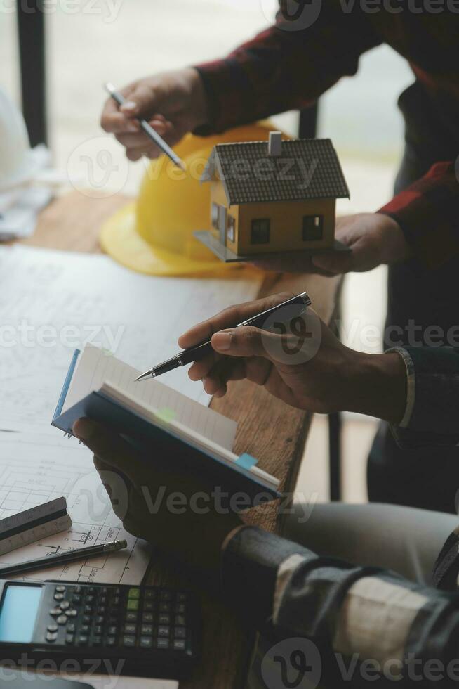 Engineer Teamwork Meeting, Drawing working on blueprint meeting for project working with partner on model building and engineering tools in working site, Construction and structure concept. photo
