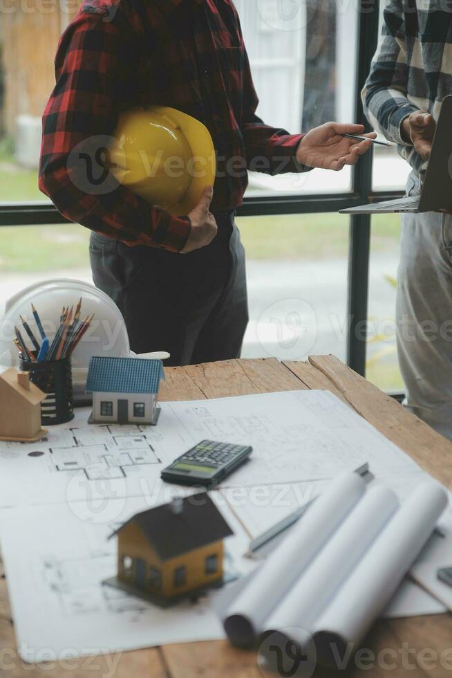 Engineer Teamwork Meeting, Drawing working on blueprint meeting for project working with partner on model building and engineering tools in working site, Construction and structure concept. photo