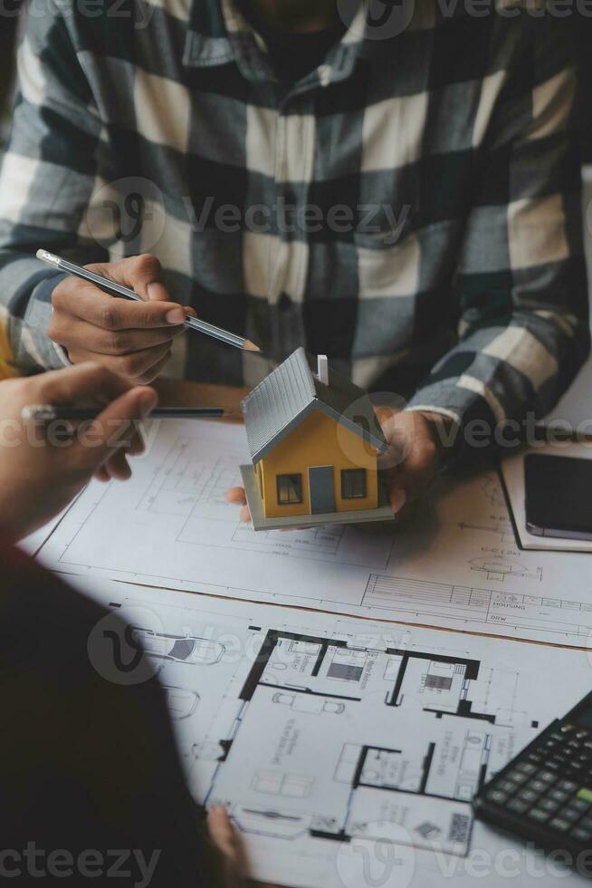 Engineer Teamwork Meeting, Drawing working on blueprint meeting for project working with partner on model building and engineering tools in working site, Construction and structure concept. photo