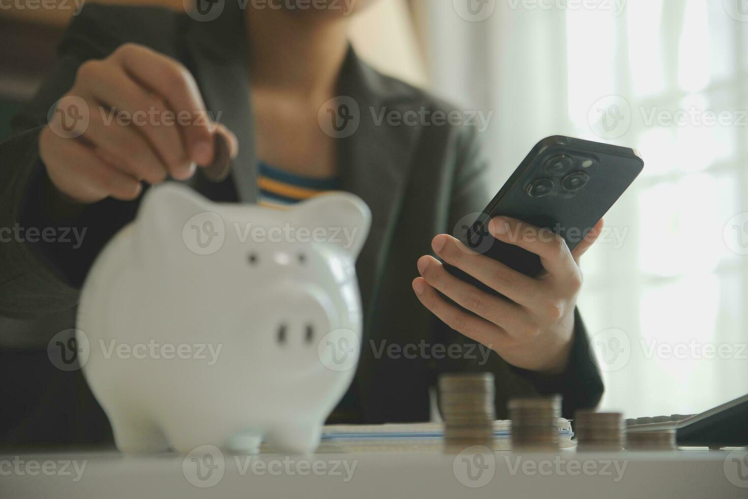 saving money and accounting concept. business man putting coin insert to jar and make acounting book for finance management to investment and saving. photo