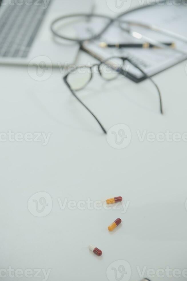 Health care billing statement with stethoscope, bottle of medicine for doctor's work in medical center stone background. photo
