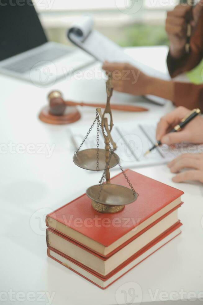 Business and lawyers discussing contract papers with brass scale on desk in office. Law, legal services, advice, justice and law concept picture with film grain effect photo