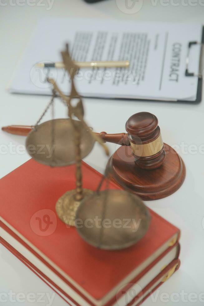 Business and lawyers discussing contract papers with brass scale on desk in office. Law, legal services, advice, justice and law concept picture with film grain effect photo