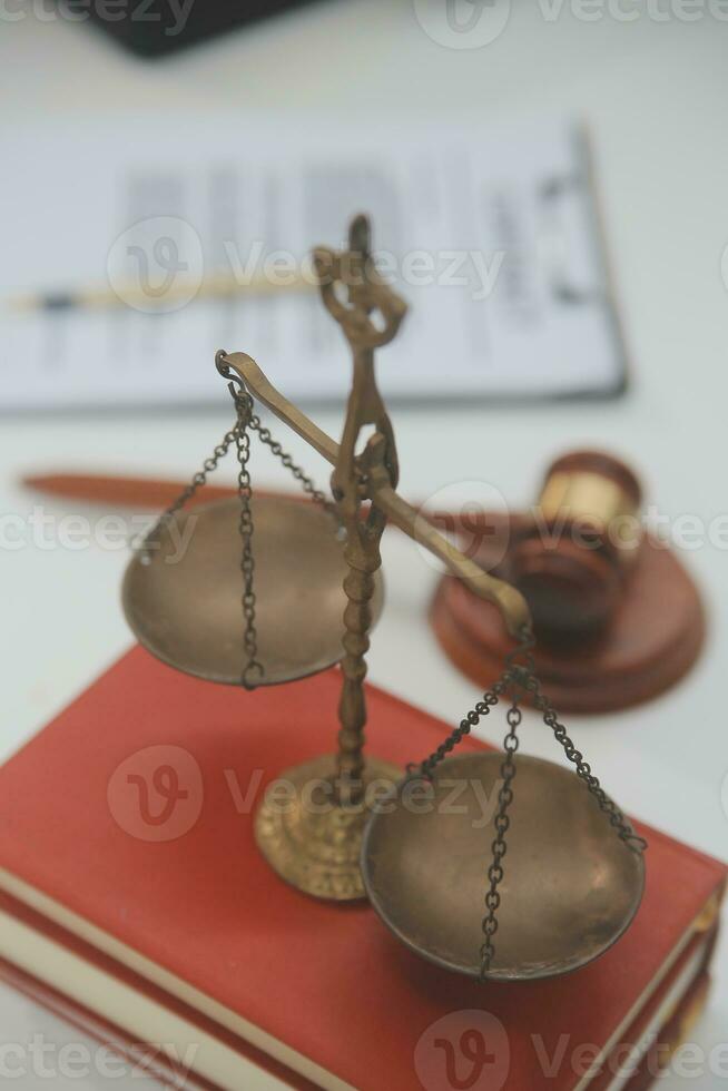 Business and lawyers discussing contract papers with brass scale on desk in office. Law, legal services, advice, justice and law concept picture with film grain effect photo