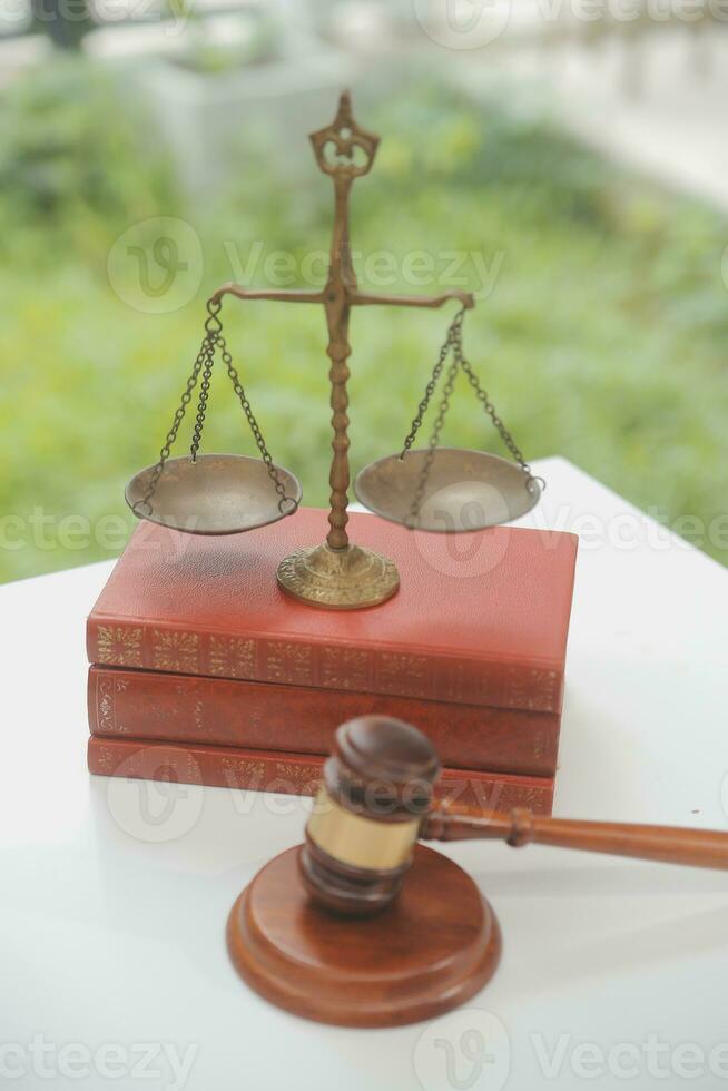 Business and lawyers discussing contract papers with brass scale on desk in office. Law, legal services, advice, justice and law concept picture with film grain effect photo
