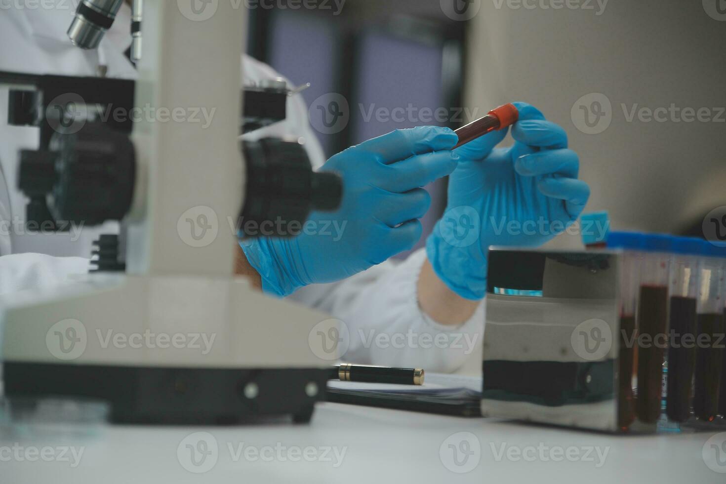 Scientist or medical in lab coat working in biotechnological laboratory, Microscope equipment for research with mixing reagents in glass flask in clinical laboratory. photo