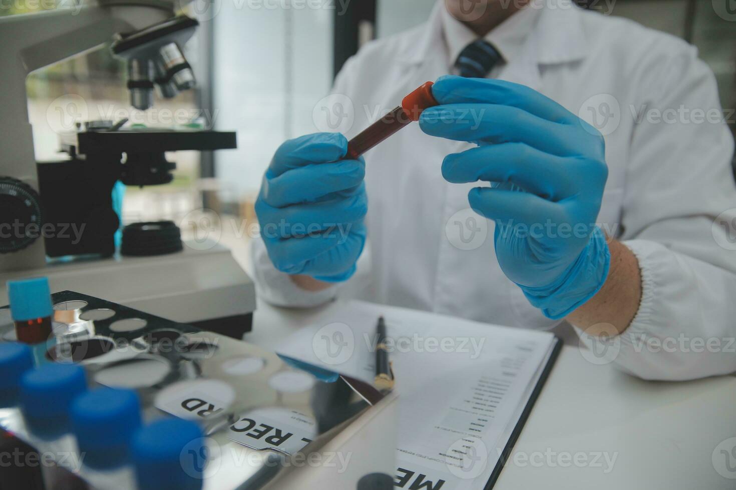 Scientist or medical in lab coat working in biotechnological laboratory, Microscope equipment for research with mixing reagents in glass flask in clinical laboratory. photo