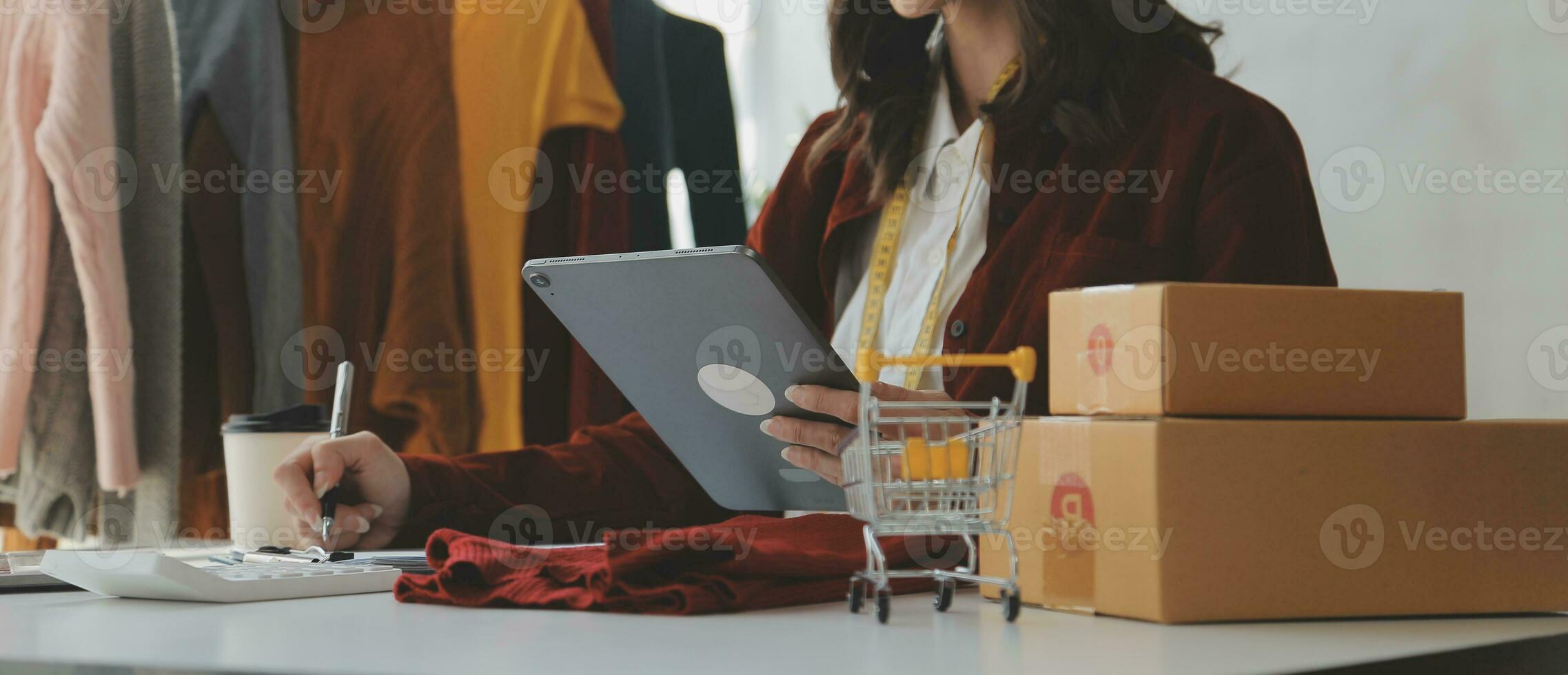 Portrait young attractive hipster asia female owner startup look at camera work happy with box at home prepare parcel delivery in sme supply chain, procurement, omnichannel ecommerce online concept. photo
