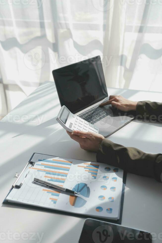 Financial Business woman analyze the graph of the company's performance to create profits and growth, Market research reports and income statistics, data,repotr,Financial and Accounting concept. photo