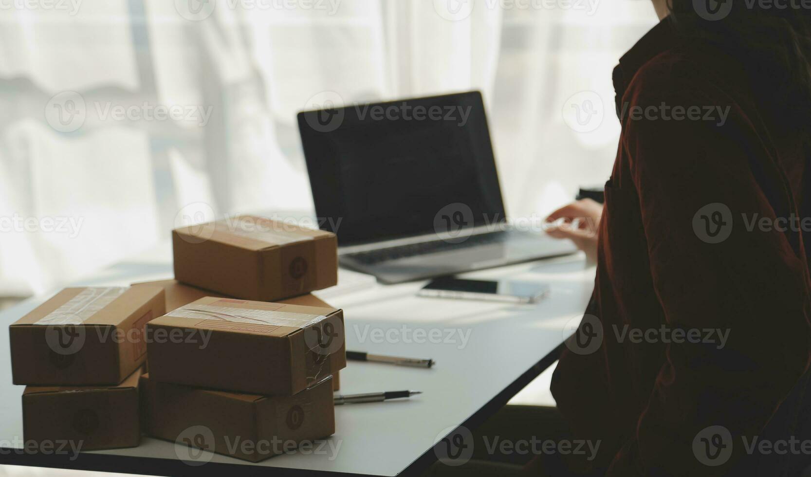 Portrait young attractive hipster asia female owner startup look at camera work happy with box at home prepare parcel delivery in sme supply chain, procurement, omnichannel ecommerce online concept. photo