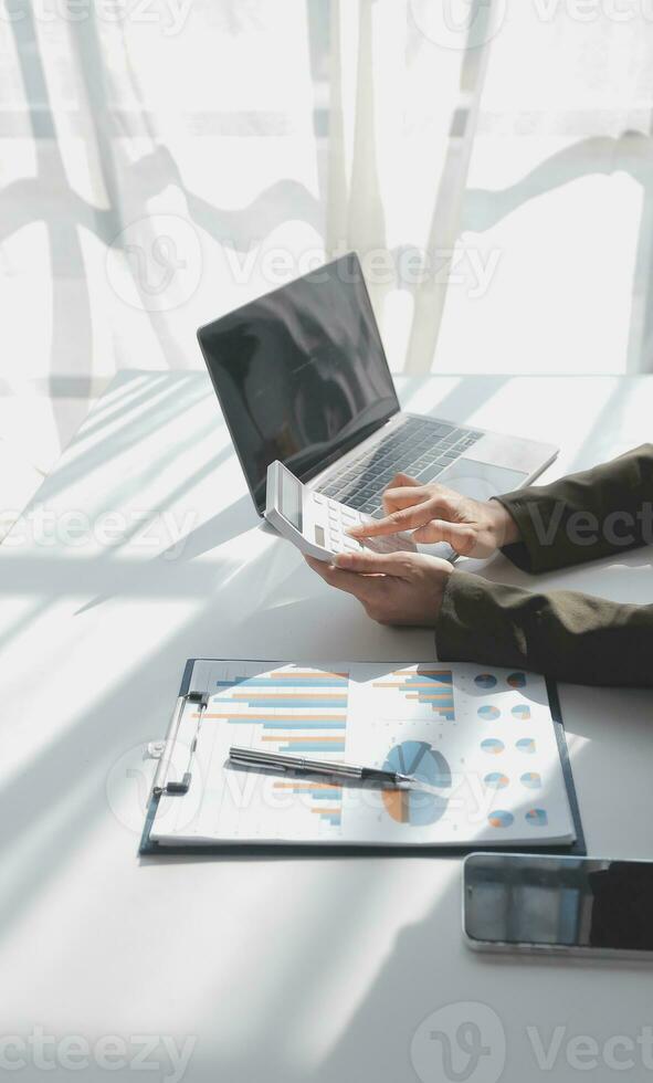 Financial Business woman analyze the graph of the company's performance to create profits and growth, Market research reports and income statistics, data,repotr,Financial and Accounting concept. photo