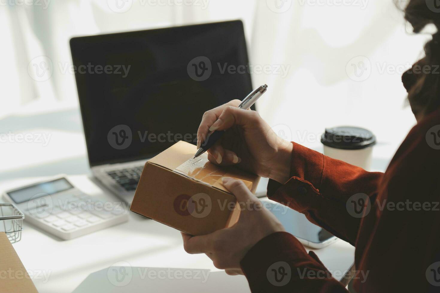 Portrait young attractive hipster asia female owner startup look at camera work happy with box at home prepare parcel delivery in sme supply chain, procurement, omnichannel ecommerce online concept. photo