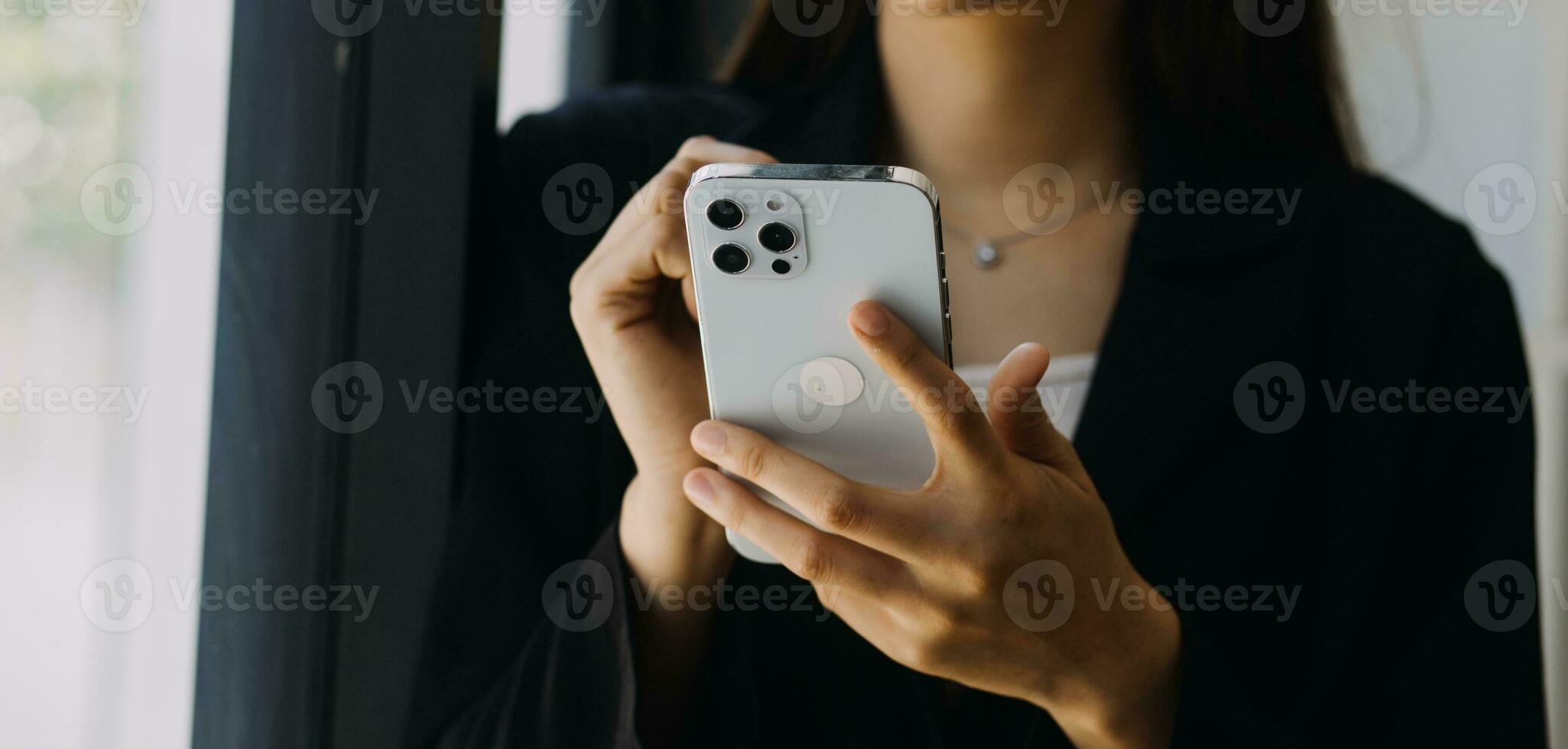 Asian Businesswoman Using laptop computer and working at office with calculator document on desk, doing planning analyzing the financial report, business plan investment, finance analysis concept. photo