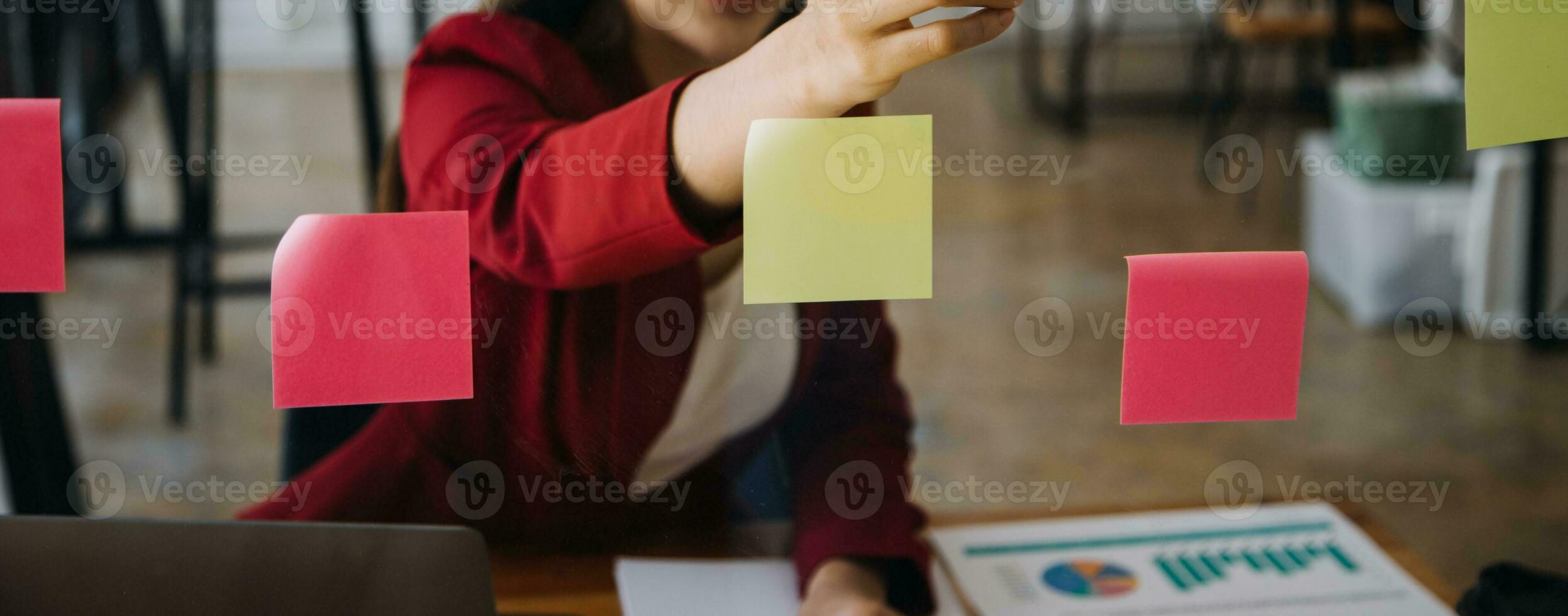 Asian Businesswoman Using laptop computer and working at office with calculator document on desk, doing planning analyzing the financial report, business plan investment, finance analysis concept. photo