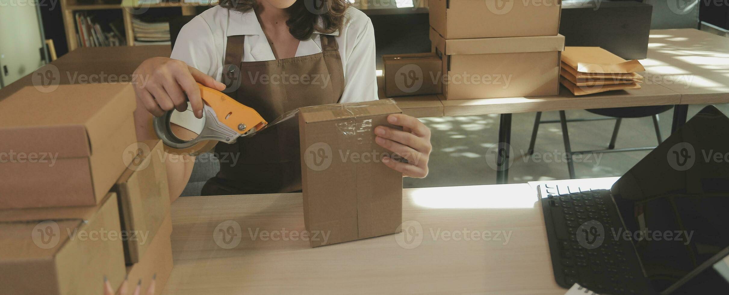 Business woman start up small business entrepreneur SME success .freelance woman working at home with Online Parcel delivery. SME and packaging deliveryconcept photo