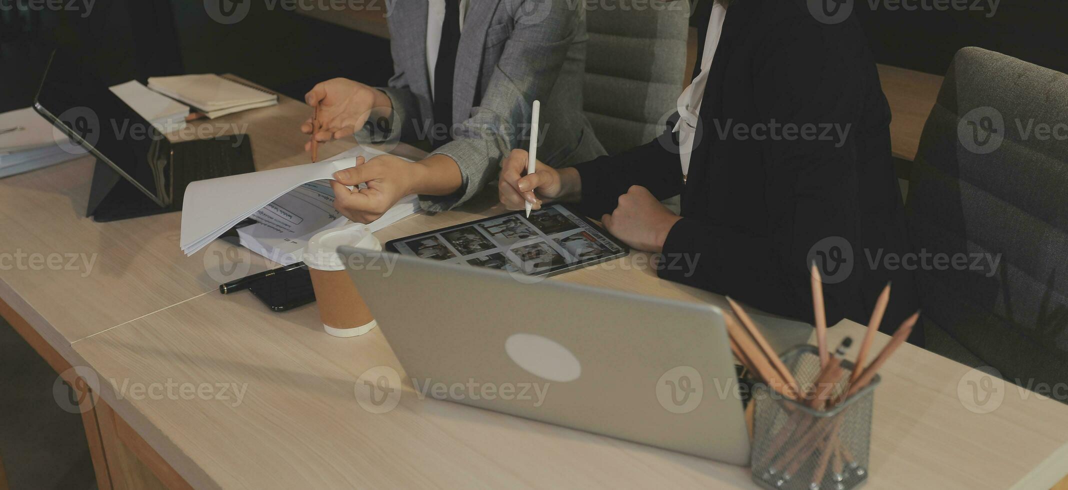 Entrepreneur Asian businessman and businesswoman discussing new business project in tablet in modern Meeting In Modern Office, Asian business casual concept. photo