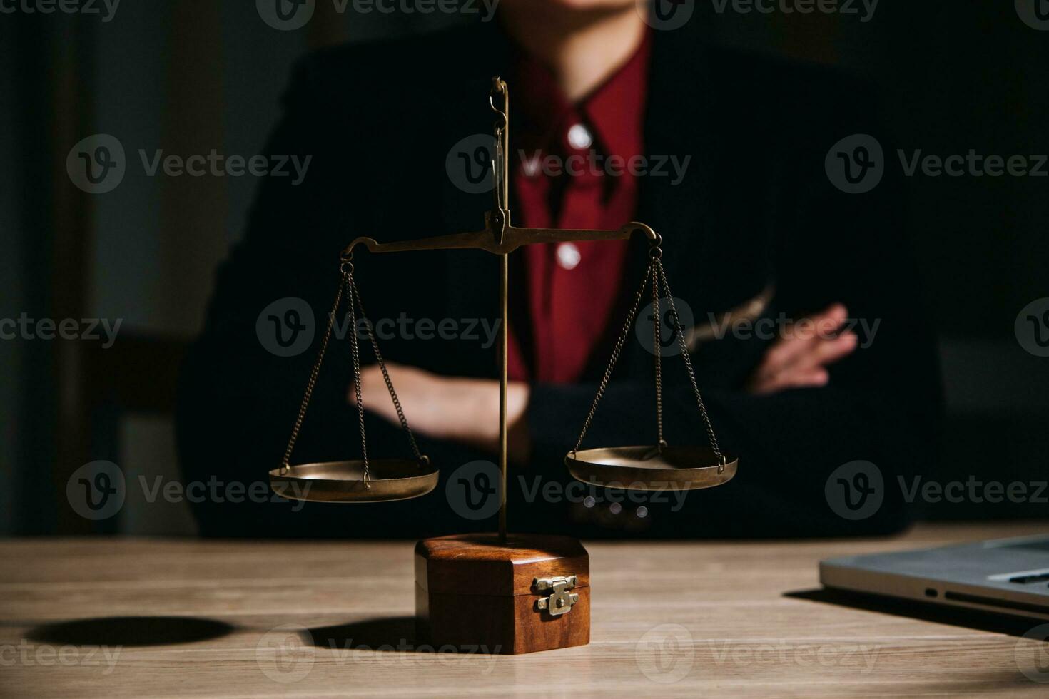 Justice and law concept.Male judge in a courtroom with the gavel, working with, computer and docking keyboard, eyeglasses, on table in morning light photo