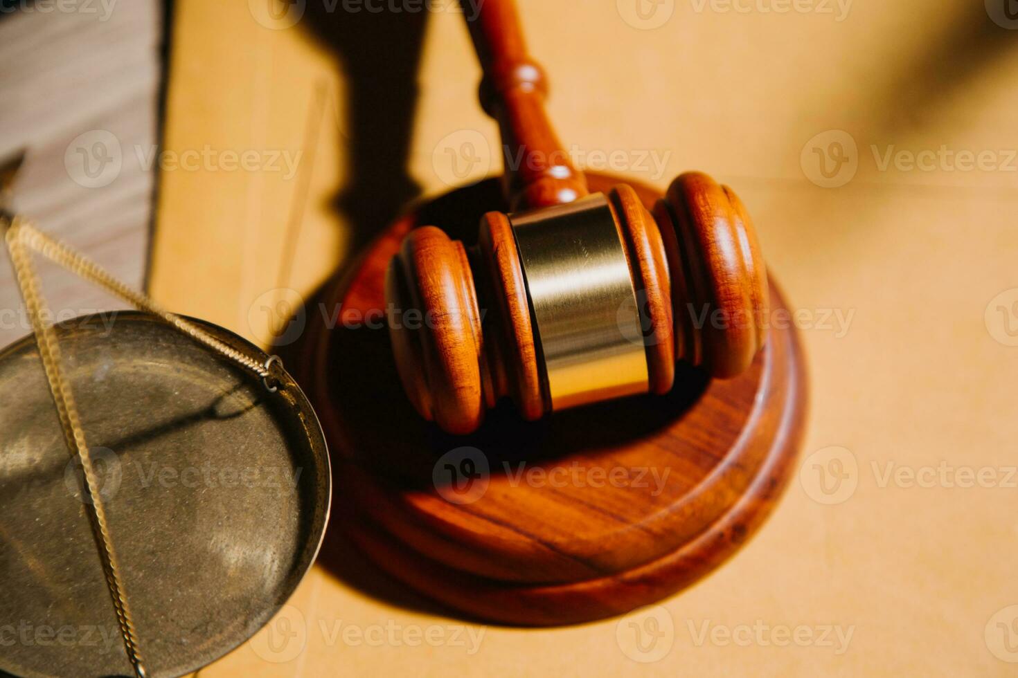 Justice and law concept.Male judge in a courtroom with the gavel, working with, computer and docking keyboard, eyeglasses, on table in morning light photo