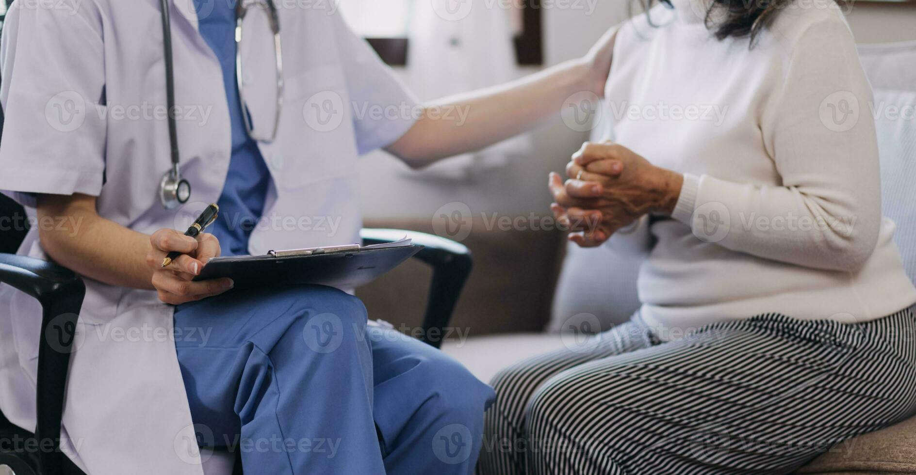 Homecare nursing service and elderly people cardiology healthcare. Close up of young hispanic female doctor nurse check mature caucasian man patient heartbeat using stethoscope during visit photo