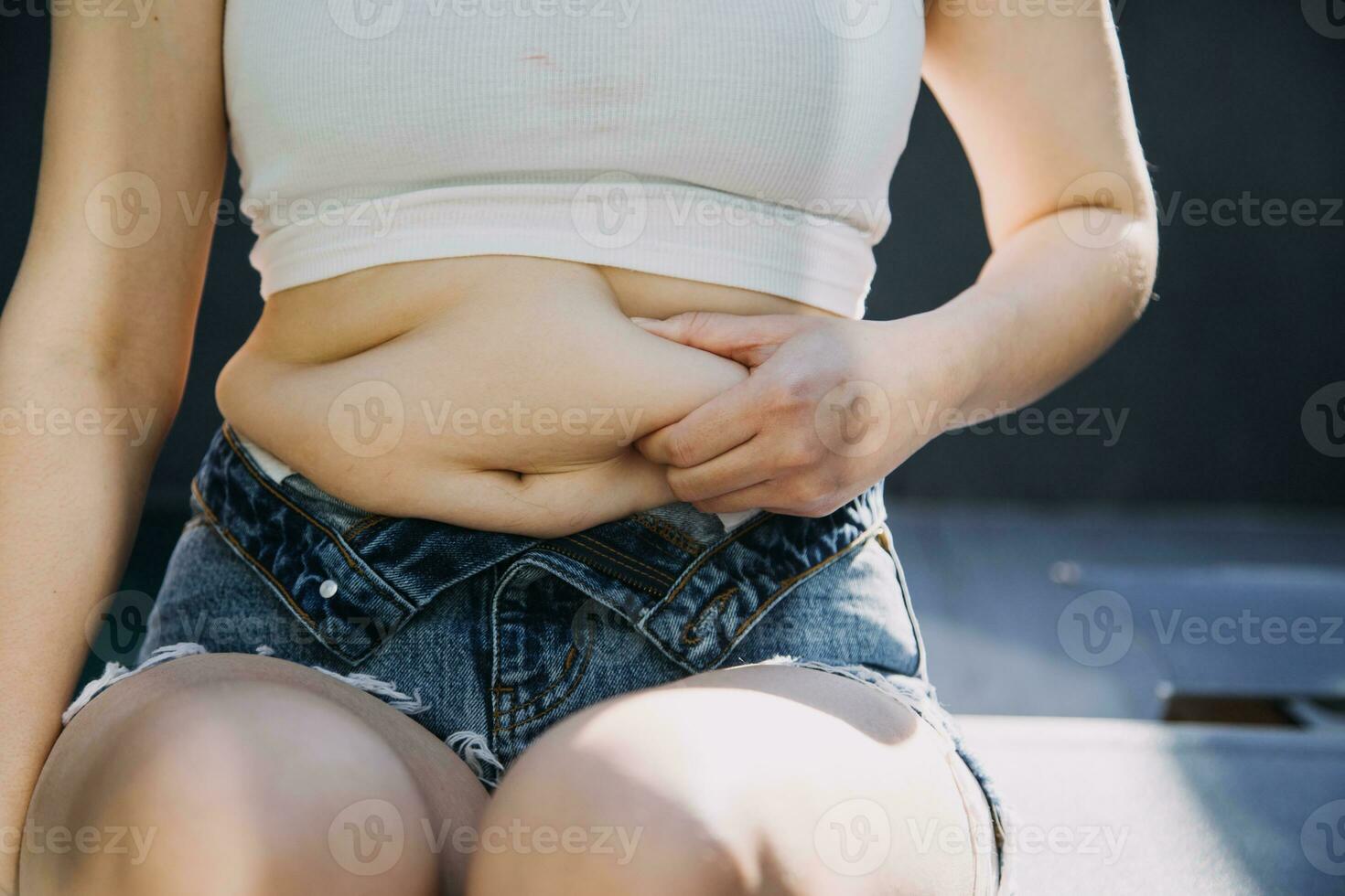 fat woman, fat belly, chubby, obese woman hand holding excessive belly fat with measure tape, woman diet lifestyle concept photo