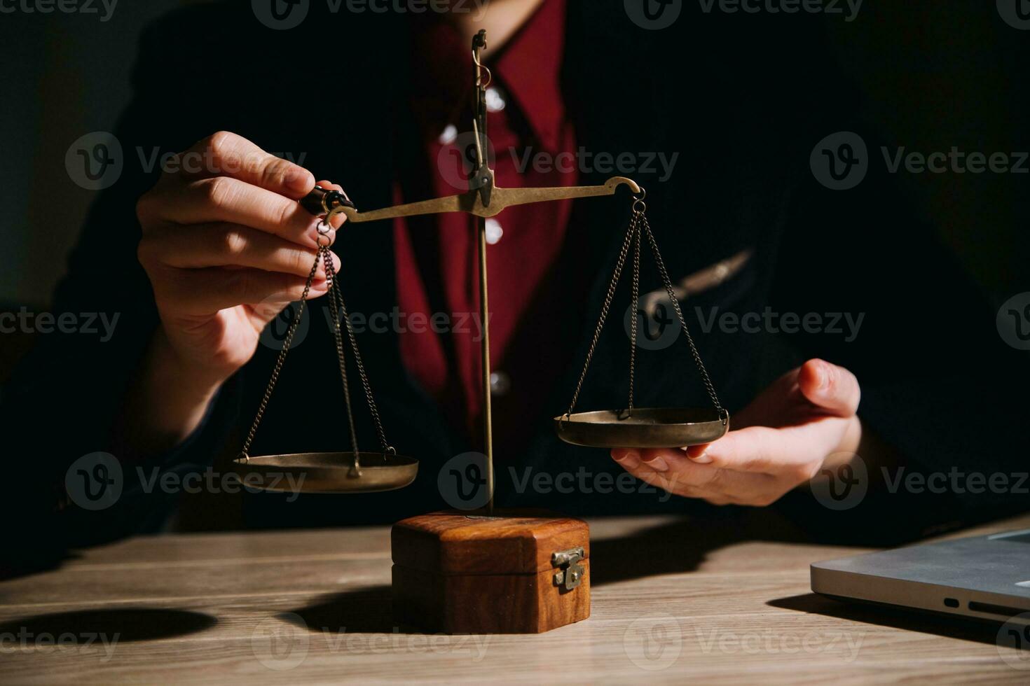 Justice and law concept.Male judge in a courtroom with the gavel, working with, computer and docking keyboard, eyeglasses, on table in morning light photo
