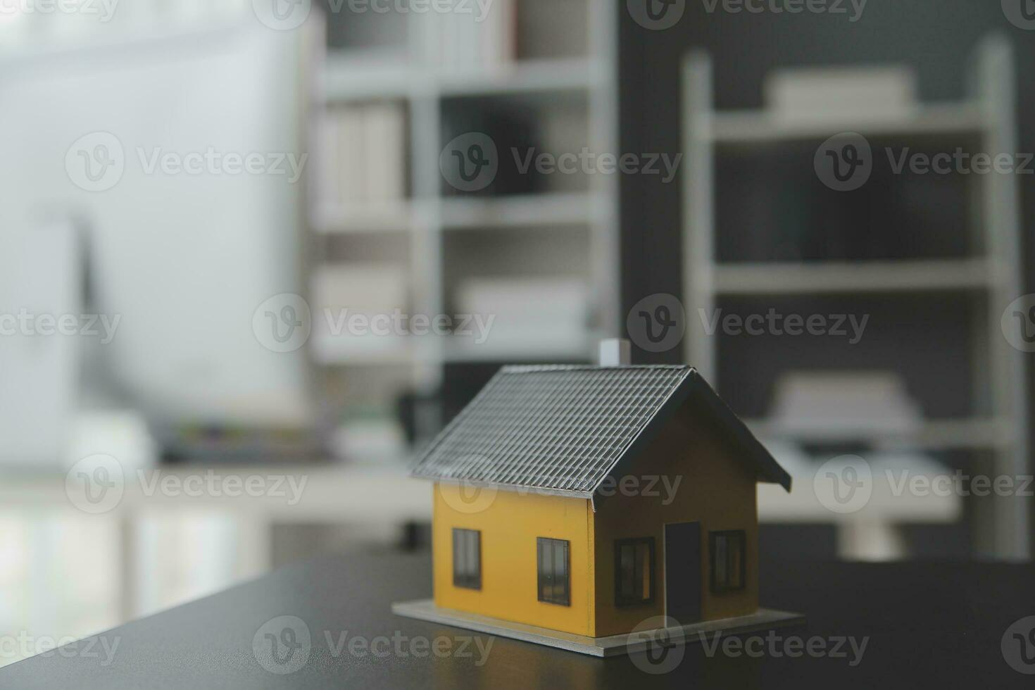 House model with real estate agent and customer discussing for contract to buy house, insurance or loan real estate background. photo