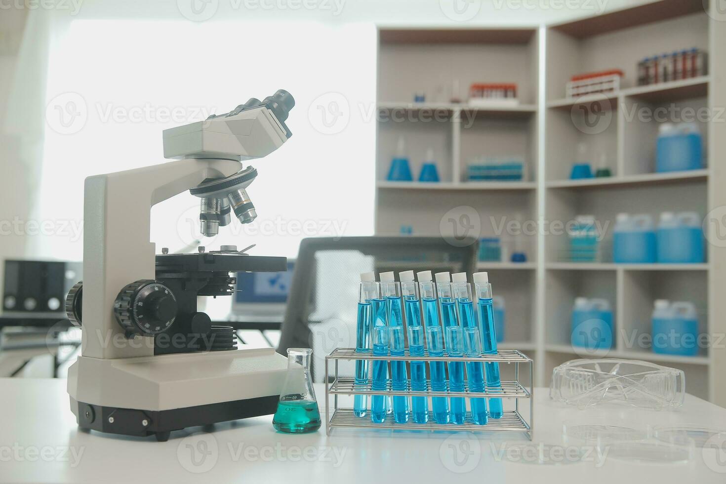 Health care researchers working in life science laboratory. Young female research scientist and senior male supervisor preparing and analyzing microscope slides in research lab. photo