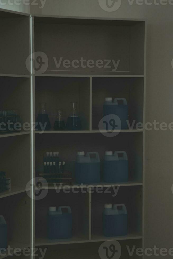 Health care researchers working in life science laboratory. Young female research scientist and senior male supervisor preparing and analyzing microscope slides in research lab. photo
