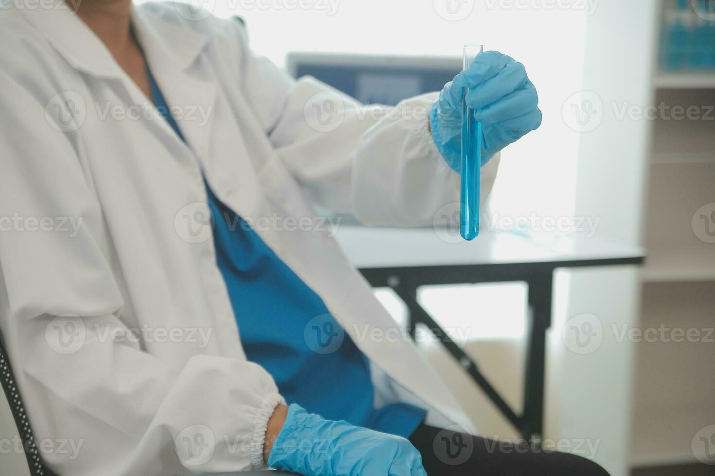 Health care researchers working in life science laboratory. Young female research scientist and senior male supervisor preparing and analyzing microscope slides in research lab. photo