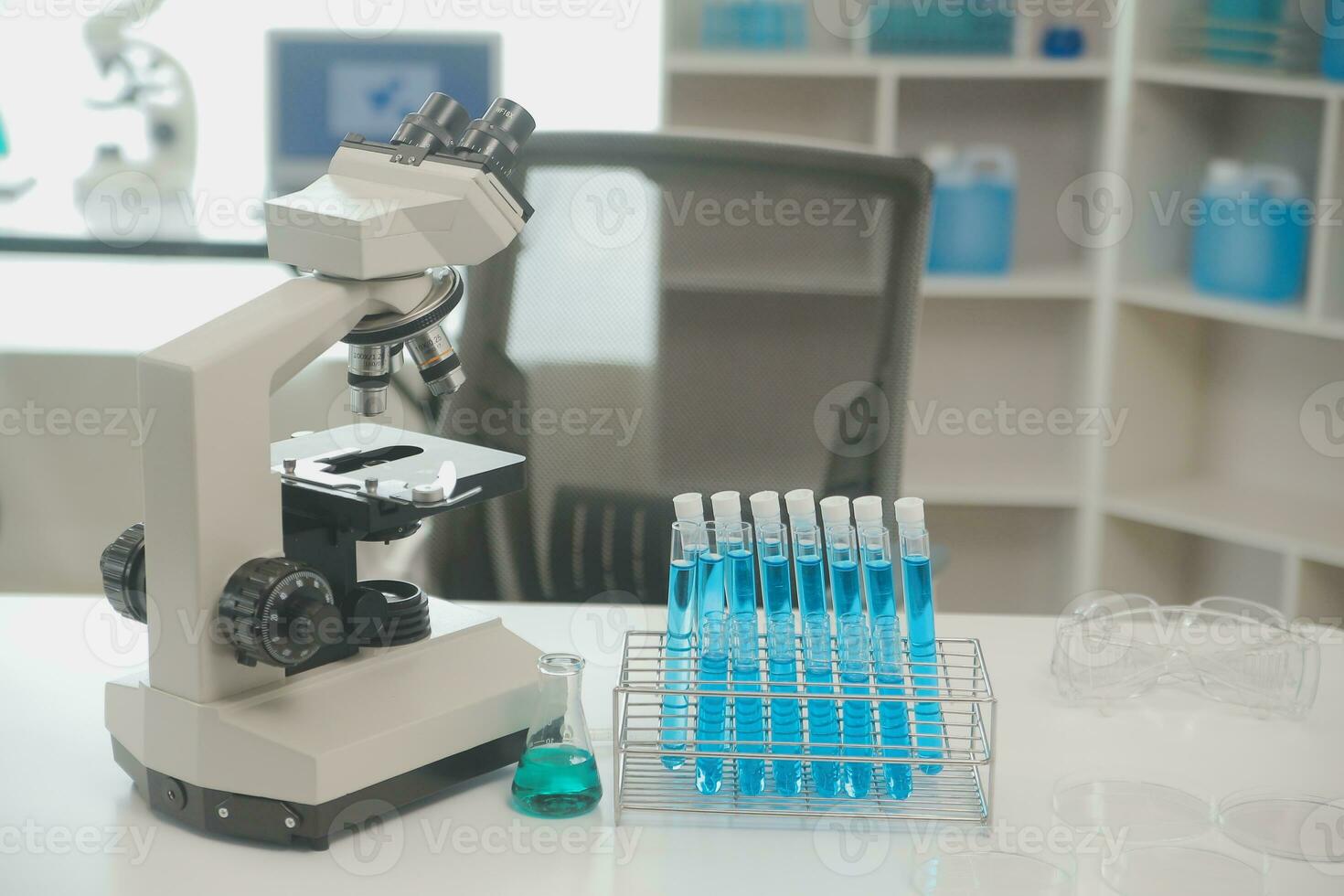 Health care researchers working in life science laboratory. Young female research scientist and senior male supervisor preparing and analyzing microscope slides in research lab. photo
