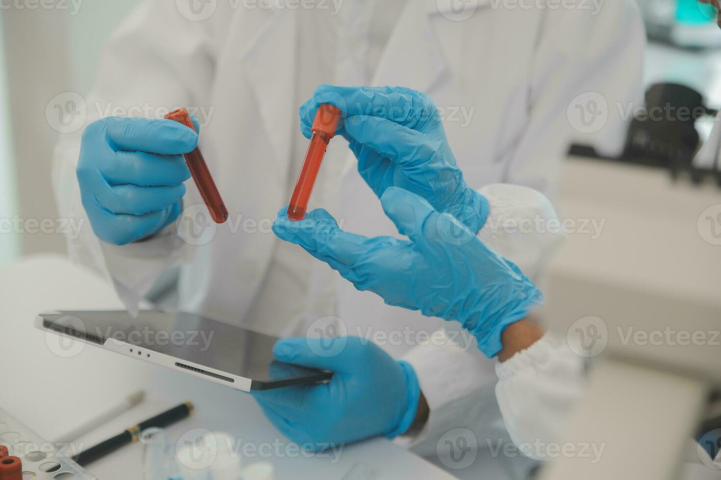 Health care researchers working in life science laboratory. Young female research scientist and senior male supervisor preparing and analyzing microscope slides in research lab. photo